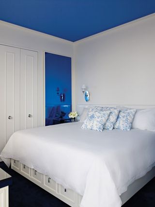 white bedroom with blue ceiling