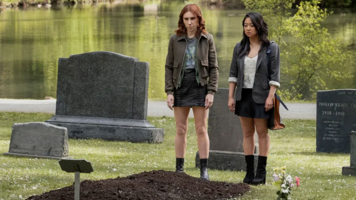 Zosia Mamet as AJ and Stephanie Hsu as Ruby stand in front of a grave in a scene from &quot;Laid&quot;