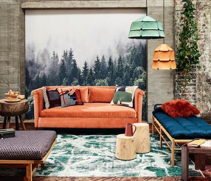 modern living room with orange sofa and green rug
