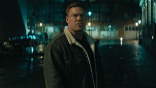 Screenshot of Reacher on the street in Season 3's Dominique episode wearing a lined jacket. 