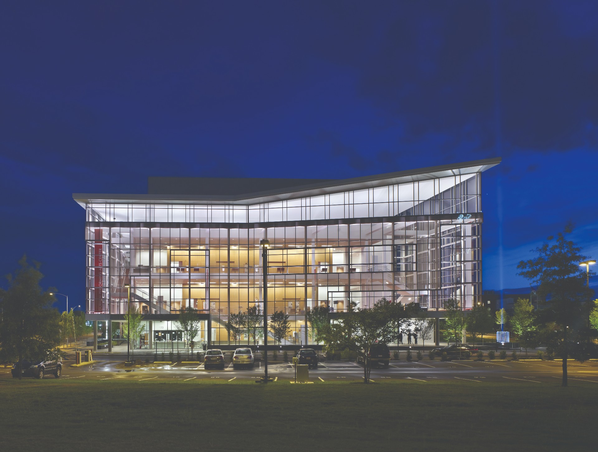 A glass building against a night sky as featured in the book 'Triangle Modern Architecture'