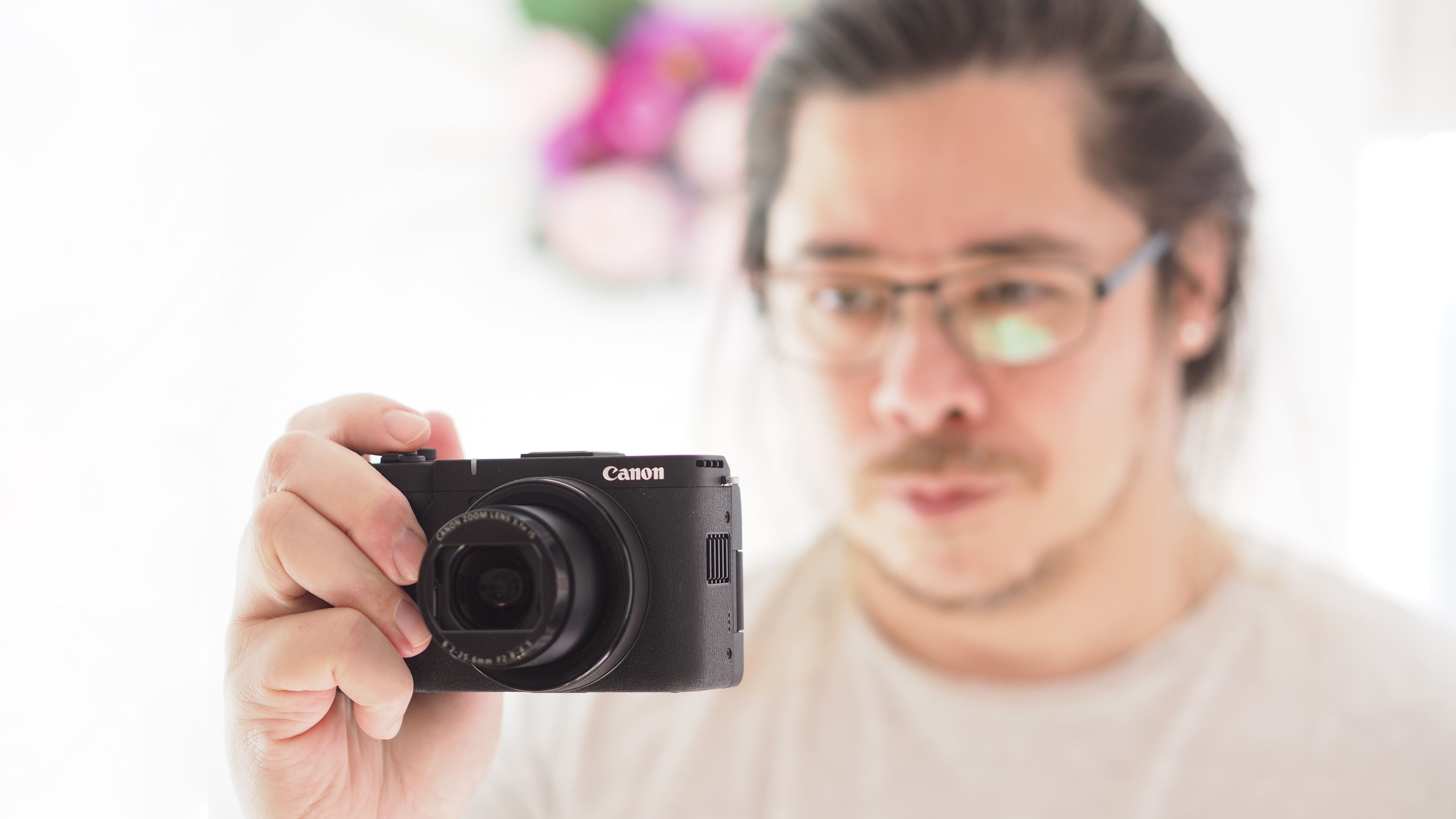 Reviewer James Artaius holding the Canon PowerShot V1
