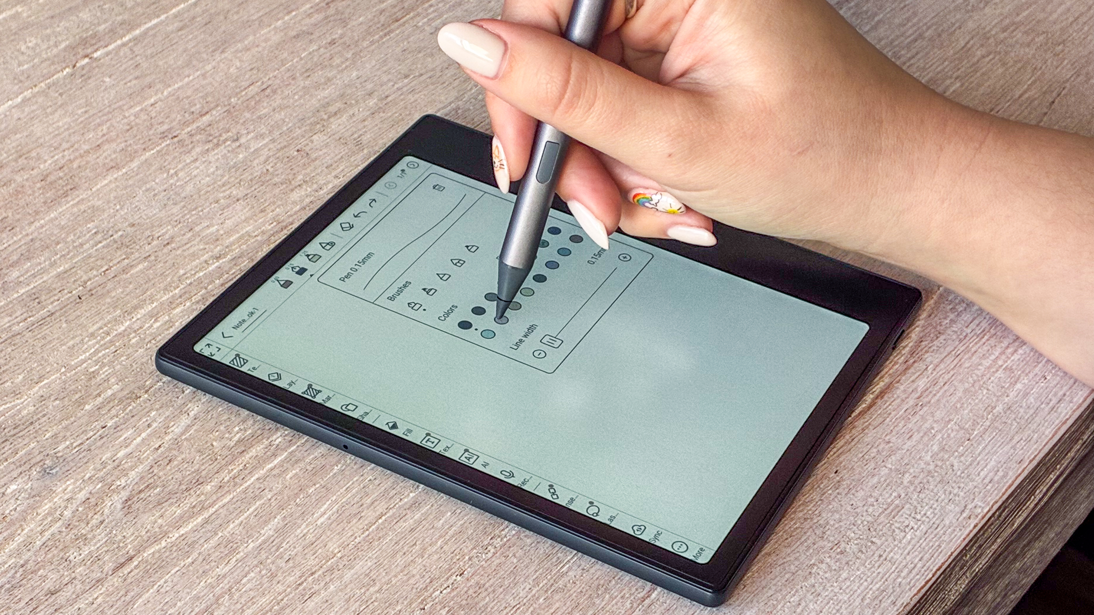 A person using the Boox Go Color 7 Gen II with the Boox InkSense stylus