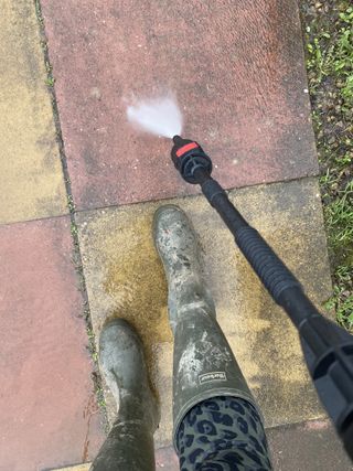 using a Bosch pressure washer to clean a garden path
