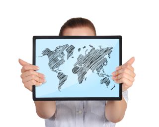 Kid holds tablet computer displaying world map