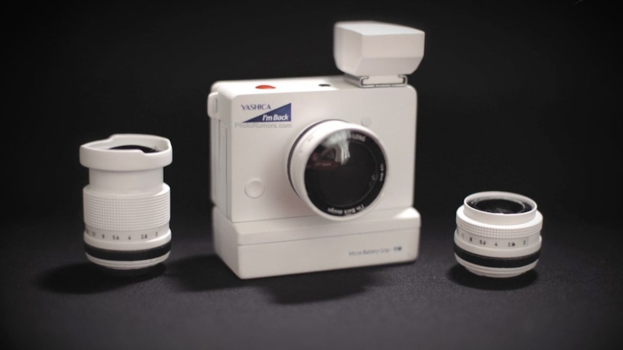 Micro Mirrorless Yashica I'm Back camera with three lenses on black background