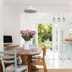 kitchen dining area with open doors out onto the garden