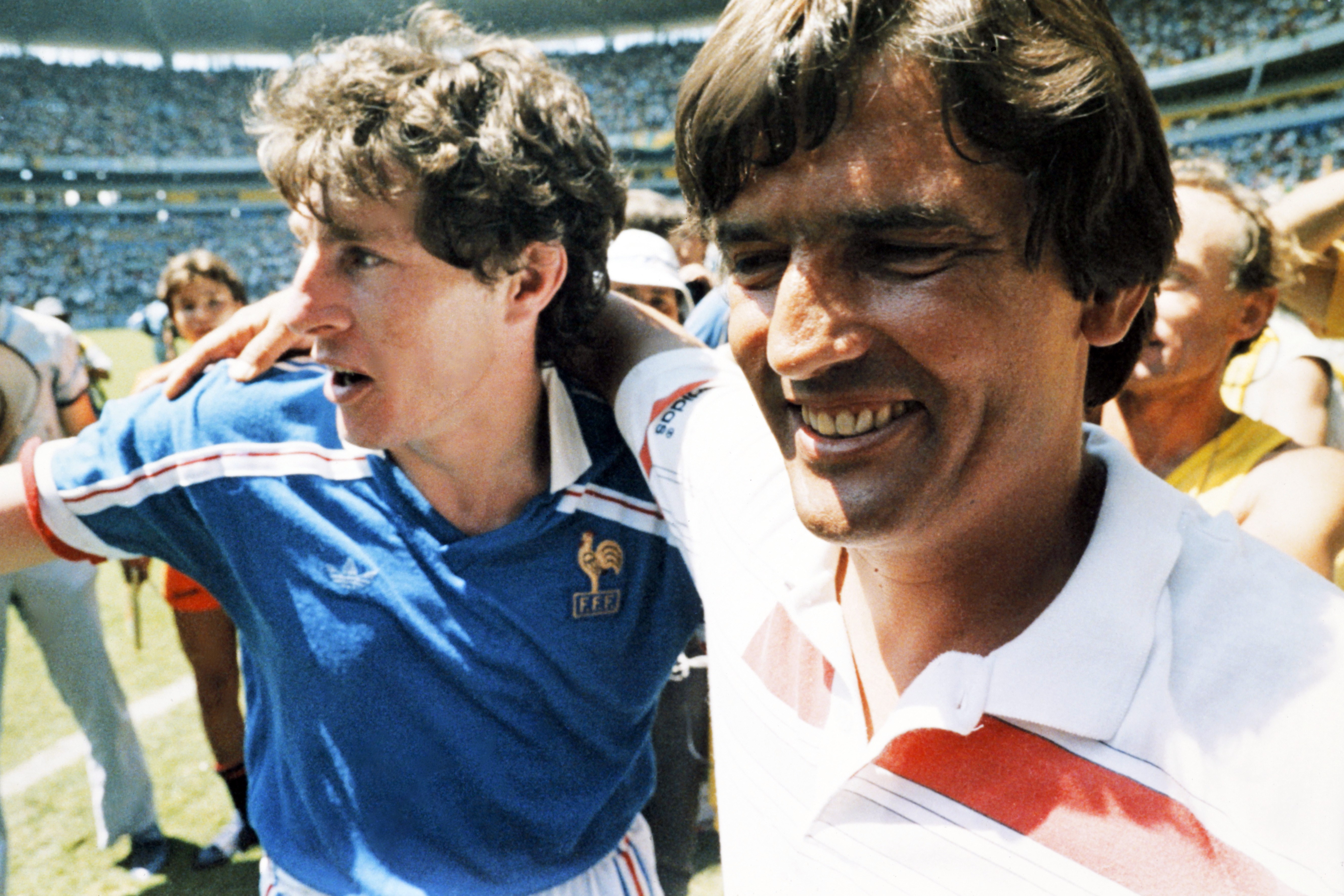 France coach Henri Michel congratulates Luis Fernandez after Les Bleus' victory over Brazil at the 1986 World Cup.