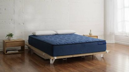 An dark blue Airweave mattress in a modern, minimalist bedroom. 