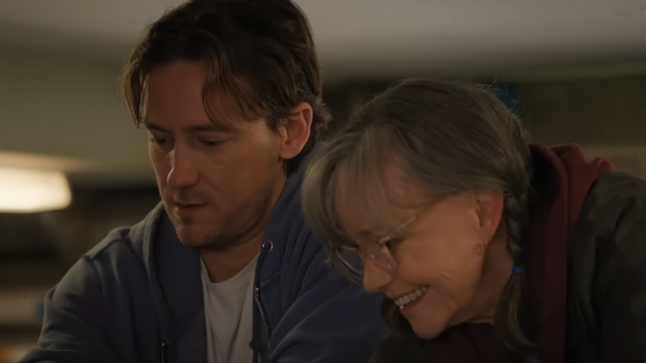 Lewis Pullman and Sally Field smiling an looking down in Remarkably Bright Creatures