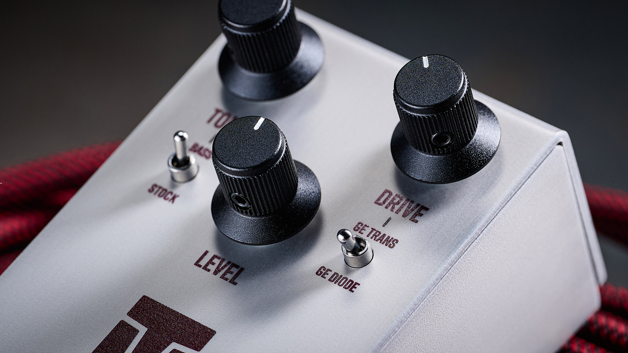 Keeley Electronics Manis: this ingenuous twist ont he K-style overdrive has three-knobs, a couple of mode switches, a tidy white finish and is photographed here against an amp with a red guitar cable.