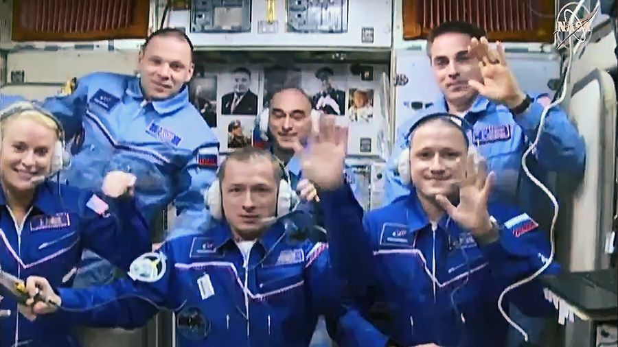 The six-person crew of Expedition 63 wave aboard the International Space Station after the arrival of NASA astronaut Kate Rubins and Russian cosmonauts Sergey Ryzhikov and Sergey Kud-Sverchkov at the International Space Station on Oct. 14, 2020.