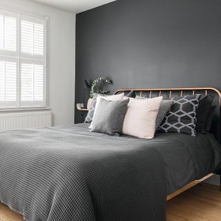 bedroom with grey wall and wooden floor