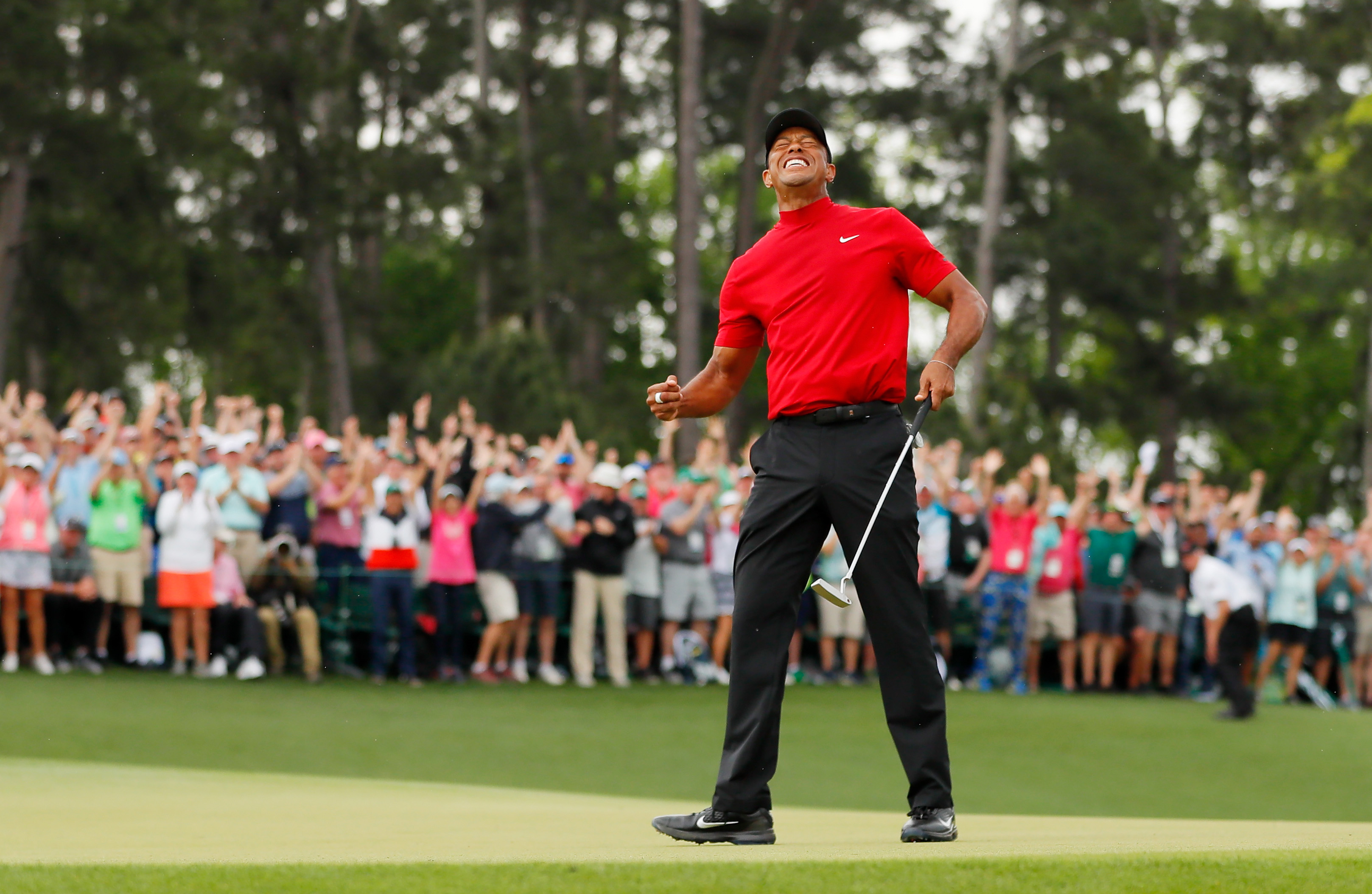 Tiger Woods celebrates on the 18th green at The Masters