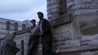 Morgan Freeman sitting near the wall of a prison in The Shawshank Redeption