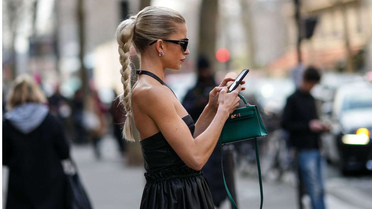 prime day deals editors picks - woman looking down at her phone - getty images 1380977892