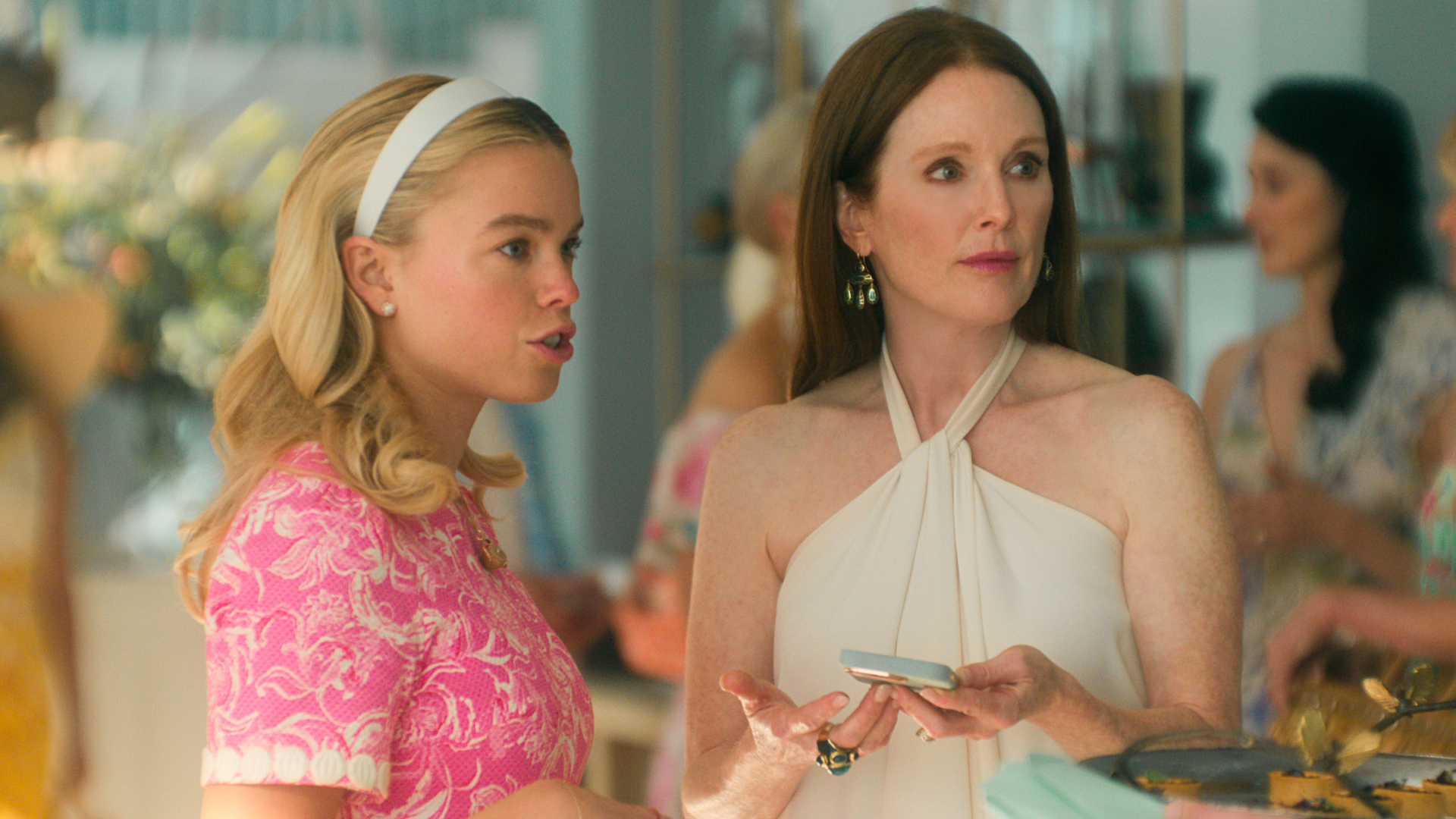 milly alcock as simone wearing a pink lilly pulitzer dress and julianne moore in a white gown at a gala in the tv show sirens