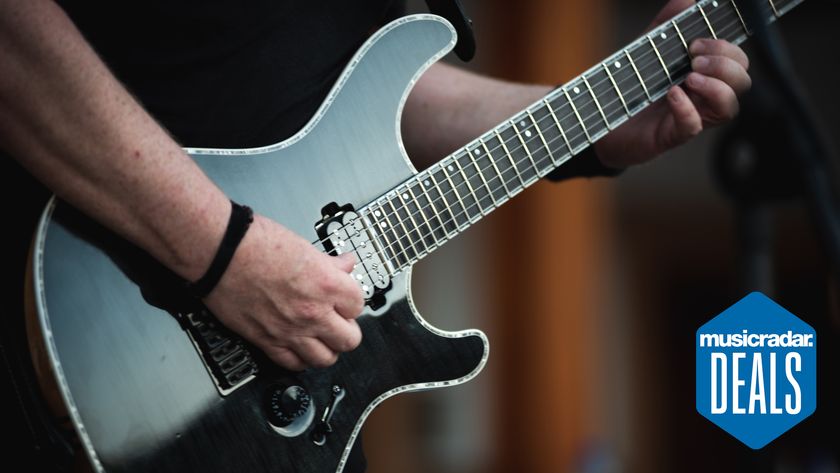 Close up of a person playing guitar