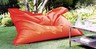 outdoor living room idea with an oversized orange beanbag