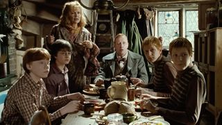 Ron, Harry, Molly, Arthur, Fred, and George at the Burrow eating breakfast in Harry Potter and the Chamber of Secrets.
