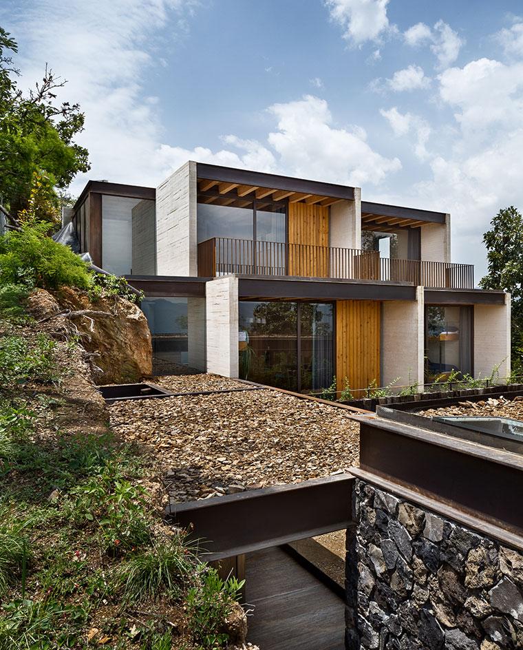 The wall planes of the two-storey bedroom block are staggered to create private pockets of outdoor space