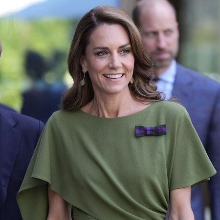 Kate Middleton wears an olive green dress with brown heels and a brown DeMellier bag at Wimbledon.