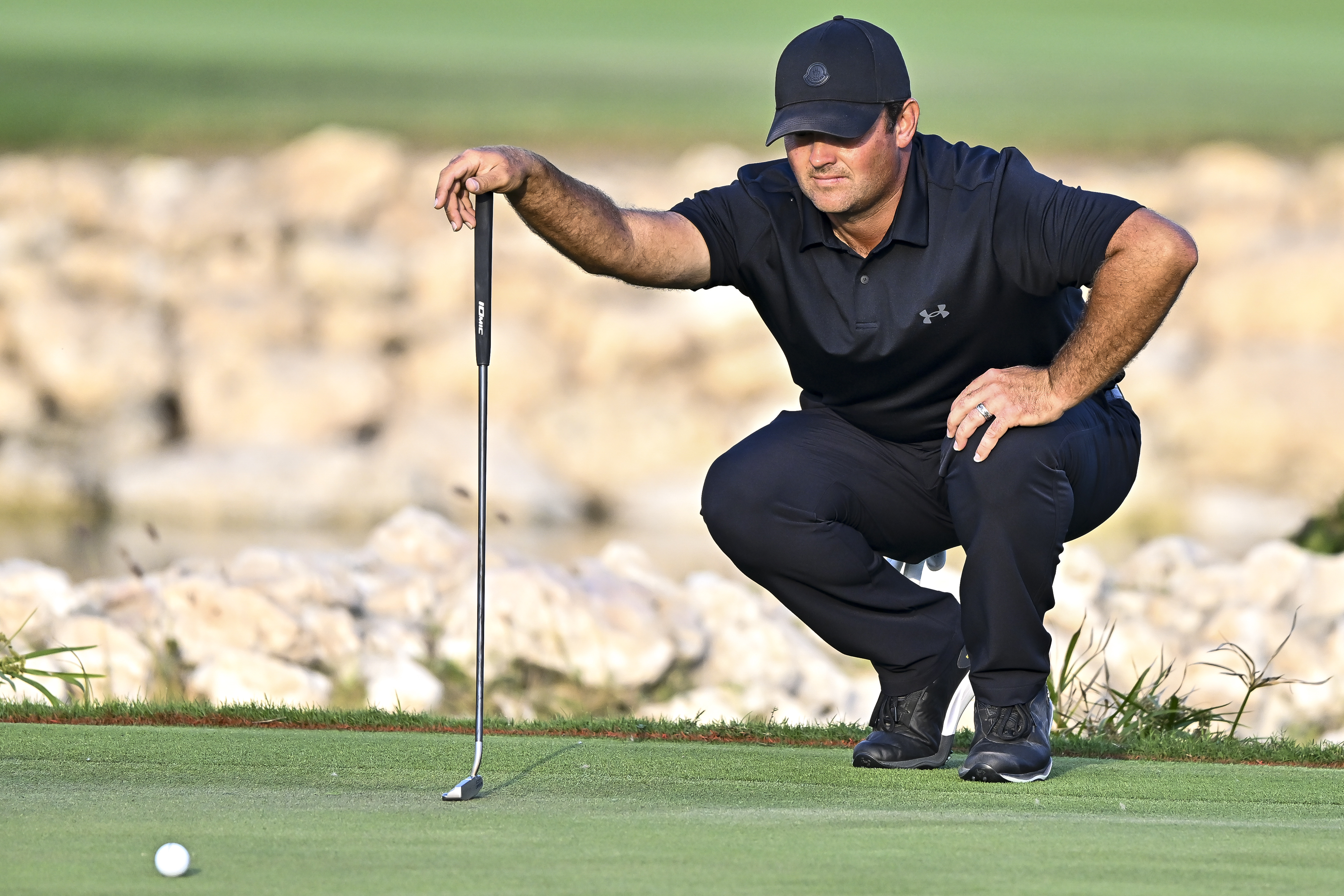 Patrick Reed lines up a putt
