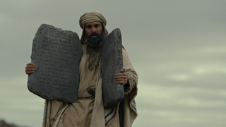 Avi Azulay as Moses holding stone tablets in Testament: The Story of Moses