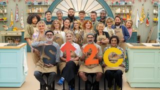 The celebrities from The Great Celebrity Bake Off 2025 lined up in the tent, all wearing their Bake off aprons.