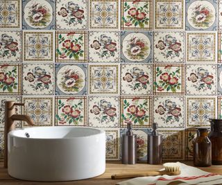 floral patterned tiles on splashback behind white sink