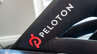 Close-up shot of the Peloton branding and logo pictured on a bicycle. 