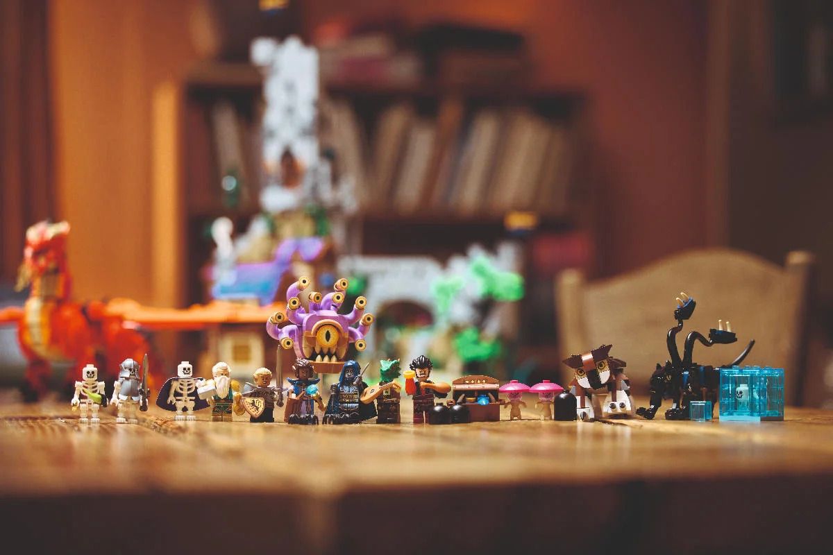 Images of the Lego D&amp;D set featuring a red dragon, beholder, and adventurer mini figs in a tavern and tower setting
