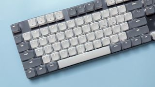 The Satechi SM3 mechanical keyboard against a blue background.