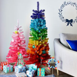 white wall with rainbow christmas tree and gifts