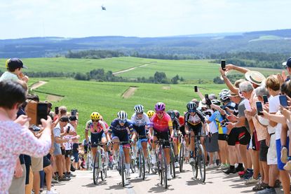 The Tour de France Femmes avec Zwift peloton wind through the crowds and the Champagne vineyards during the 2022 race