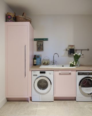 A pale pink utility room.
