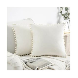 white throw pillow with tassels