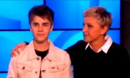 Justin Bieber showed off his shorn locks on "The Ellen Degeneres Show" and offered the host a box of his hair for charity. 