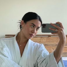 Woman taking a mirror selfie with an iPhone