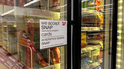 A sign advertising SNAP food stamps is seen on a fridge at a Walgreens in Queens, New York.