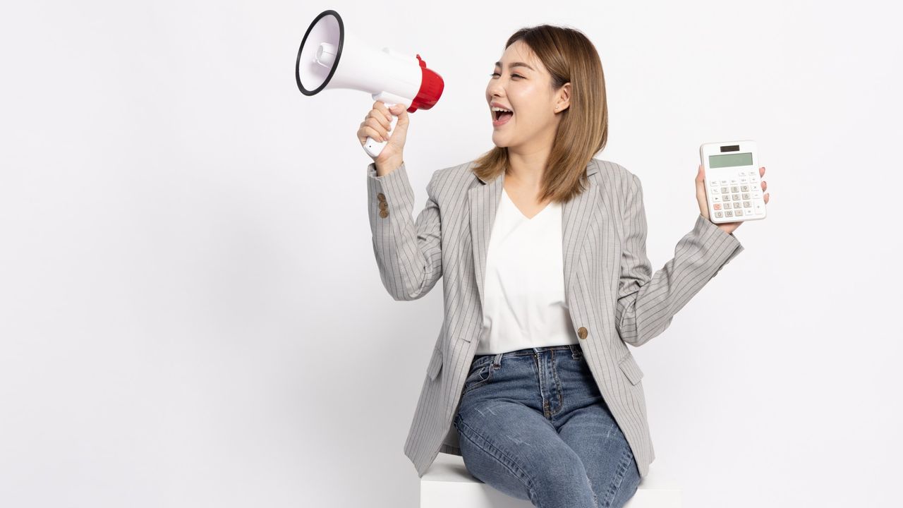 Woman holding loudspeaker and calculator