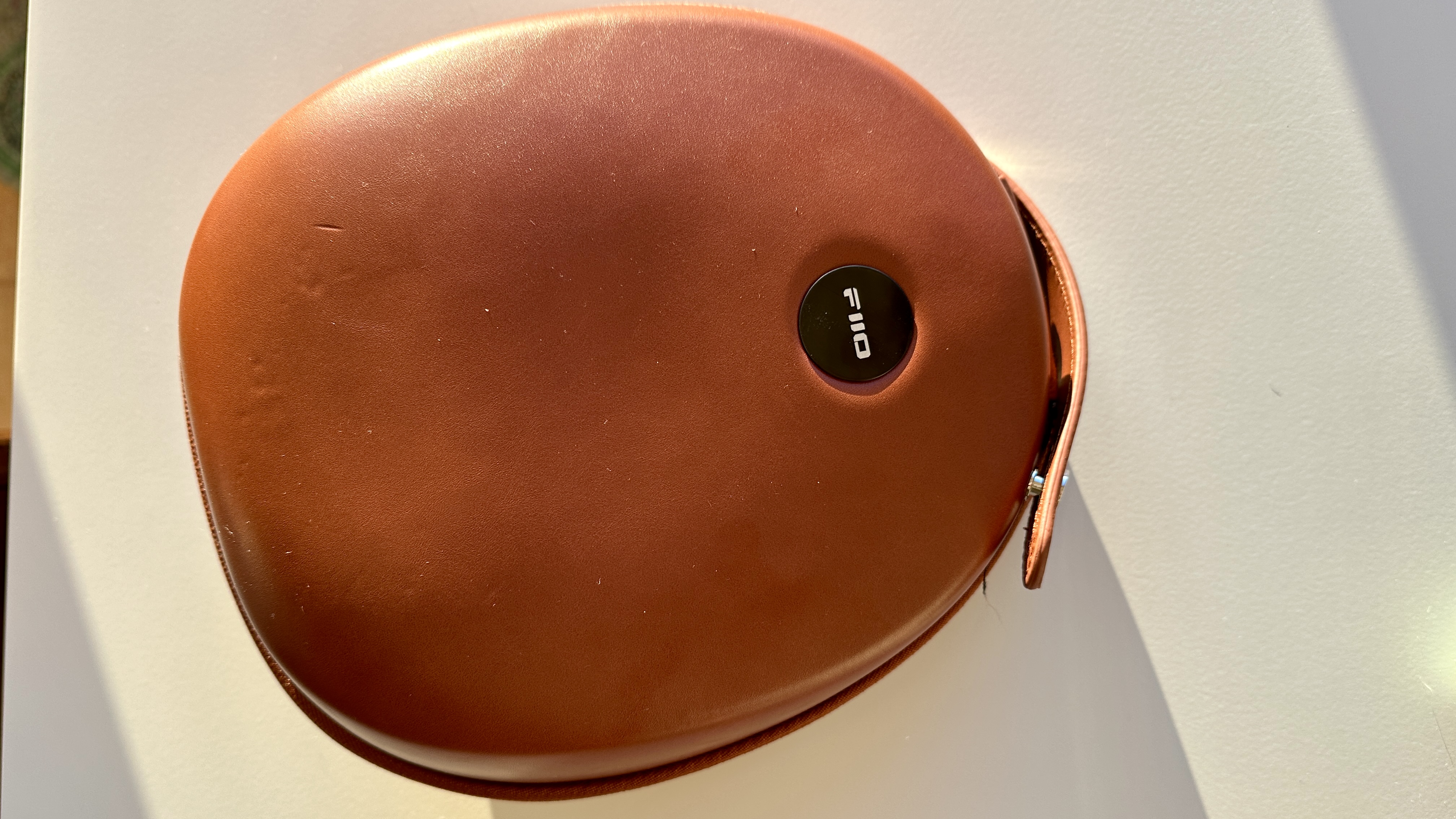 Fiio FT5 headphones case, on a beige table