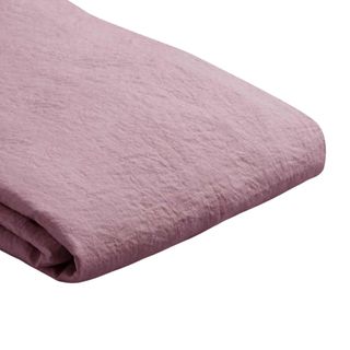 A folded raspberry pink-purple linen duvet cover 