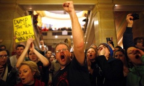 Protesters react to Gov. Scott Walker&amp;#039;s appearance Monday; the Republican governor has said he&amp;#039;s willing to prolong the government shutdown until his bill passes.