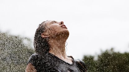 A young woman standing in the rain