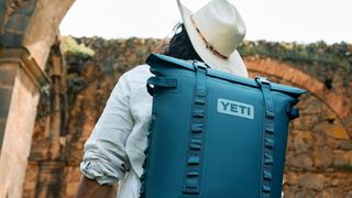 Man carrying Yeti backpack in Agave colorway