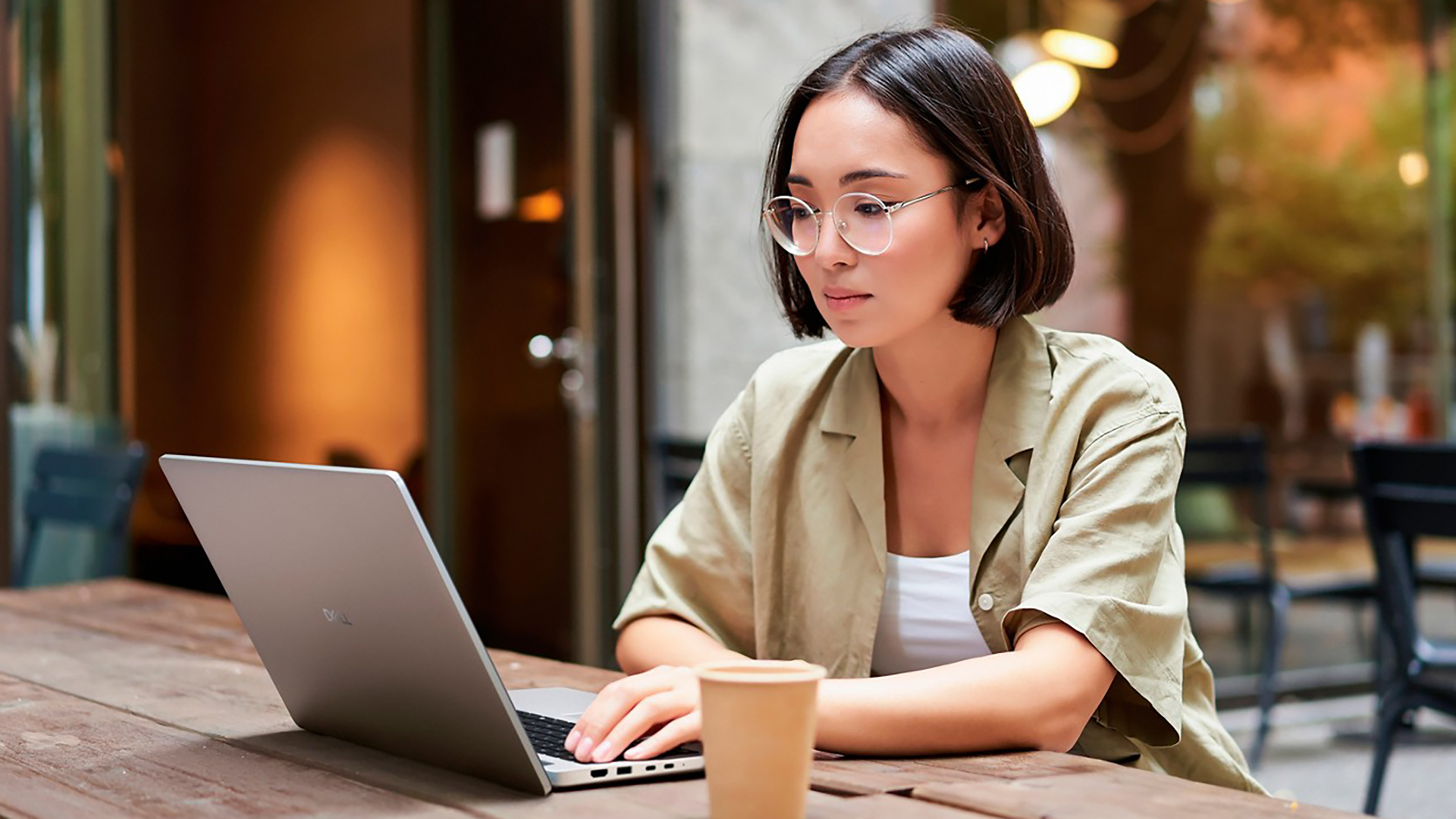 A woman using a Dell Pro laptop