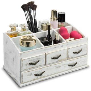 White wooden makeup organizer filled with products