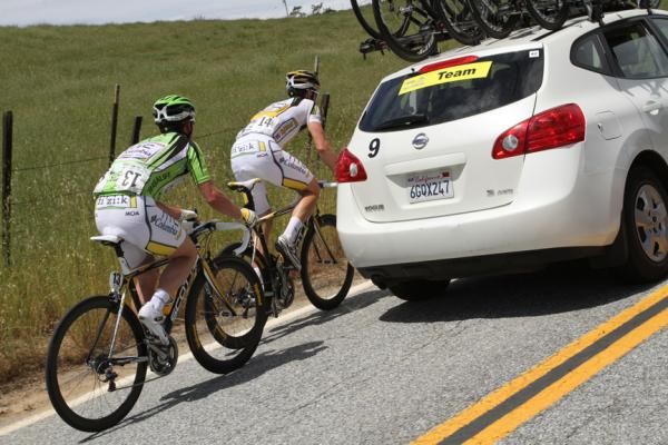 Mark Cavendish is paced back through the caravan after a puncture on Sierra Road