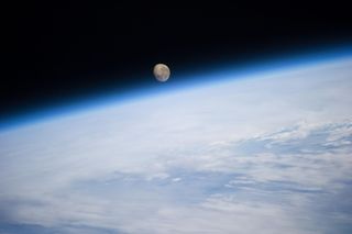 View of Moon setting over an Earth limb taken by the Expedition 40 crew aboard the International Space Station (ISS).